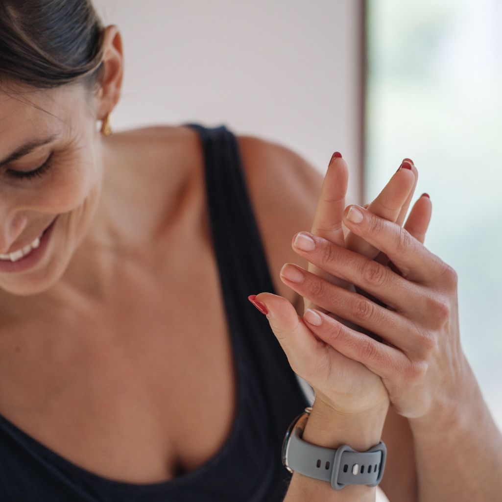 Woman holding her yoga students hand